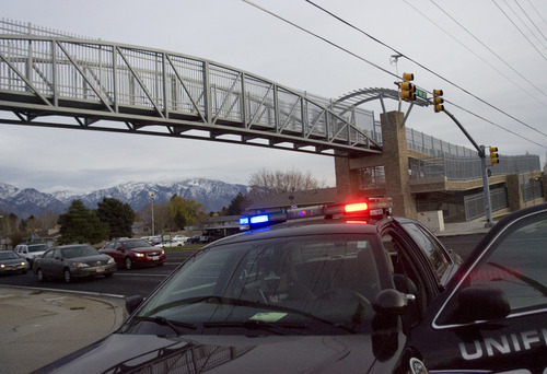 Kim Raff  |  The Salt Lake Tribune
Firefighters and police officers respond to the scene of teen's suicide on the pedestrian bridge near Bennion Junior High School in Taylorsville on Nov. 29, 2012.