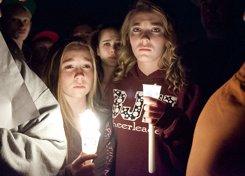 Students mourn during a vigil for a student who died in an apparent suicide on a pedestrian bridge near Bennion Junior High School in Taylorsville, Utah, on Thursday, Nov. 29, 2012.  Granite School District spokesman Ben Horsley says a 14-year-old boy had left Bennion Junior High with his mother about 1:30 p.m. Thursday. The ninth-grader later returned to a pedestrian bridge near the school just before 3 p.m. and came upon several students who had just gotten out of school for the day, said Unified Police Lt. Justin Hoyal. He pulled out a handgun and shot himself in the head, Hoyal said. He was taken by ambulance but died a short while later. Police are not yet identifying the teenager. More than 200 people gathered at the bridge, candles in hand, for a vigil. (AP Photo/The Salt Lake Tribune, Kim Raff)  DESERET NEWS OUT; LOCAL TV OUT; MAGS OUT