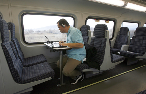 Francisco Kjolseth  |  The Salt Lake Tribune
Randall Jeppesen with KSL Radio takes advantage of power outlets and free onboard wi-fi as he works on the FrontRunner train during a media invitation to ride the new FrontRunner line from Salt Lake City to Provo on Friday, November 30, 2012, as UTA gets ready to open for regular service on Monday, December 10, 2012. The public is also welcome to try out the line as part of their "Food for your fare" on Saturday, December 8, 2012, from 10 a.m to 10 p.m by providing a non-perishable food item to be donated as "fare" to benefit the Utah Food Bank and the Community Action Services.