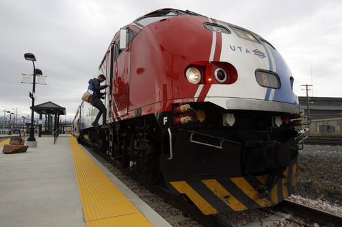 Francisco Kjolseth  |  The Salt Lake Tribune
Provo Herald photographer Spencer Heaps climbs down from the engine following a media invitation to ride the new FrontRunner line from Salt Lake City to Provo on Friday, November 30, 2012, as UTA gets ready to open for regular service on Monday, December 10, 2012. The public is also welcome to try out the line as part of their "Food for your fare" on Saturday, December 8, 2012, from 10 a.m to 10 p.m by providing a non-perishable food item to be donated as "fare" to benefit the Utah Food Bank and the Community Action Services.
