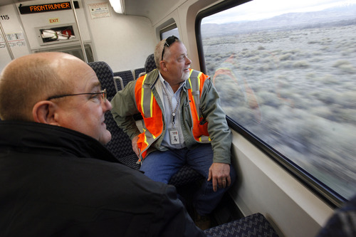 Francisco Kjolseth  |  The Salt Lake Tribune
Fred Engum, left, a contractor for UTA, and Joel Gray, a maintenance supervisor for UTA, look out into South Jordan as they ride the new FrontRunner line from Salt Lake City to Provo on Friday, November 30, 2012, as UTA gets ready to open for regular service on Monday, December 10, 2012. The public is also welcome to try out the line as part of their "Food for your fare" on Saturday, December 8, 2012, from 10 a.m to 10 p.m by providing a non-perishable food item to be donated as "fare" to benefit the Utah Food Bank and the Community Action Services.