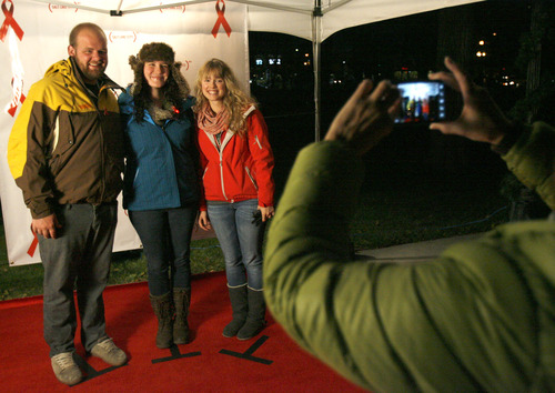 Rick Egan  | The Salt Lake Tribune 

Bryson Vomdorf (left) Chrissy Upton, and Paige Musgraves pose for photo in the photo booth for World AIDS Day at the City-County Building, Saturday, December 1, 2012.The culmination of the event is a red lighting of the City & County Building and a bell-ringing tribute to those who have lost their lives to HIV/AIDS and those who continue to be affected by the disease.