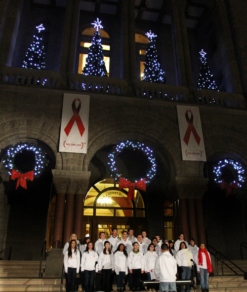 Rick Egan  |  The Salt Lake Tribune 
The Rowland Hall Choir sings for World AIDS Day event at the Salt Lake City-County Building Saturday, December 1, 2012. The culmination of the event is a red lighting of the City-County Building and a bell-ringing tribute to those who have lost their lives to HIV/AIDS and those who continue to be affected by the disease.