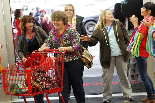 Al Hartmann  |  The Salt Lake Tribune
Customers pour through the doors at Trader Joe's into a party atmosphere for the opening of the new store at 634 East 400 South in Salt Lake City Friday November 30 at 8 a.m.