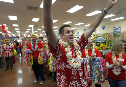 Al Hartmann  |  The Salt Lake Tribune
Rory Violette, the "captain", manager of the new Trader Joe's rallies the employees dressed for the party-like opening of the store at 634 East 400 South in Salt Lake City Friday November 30.