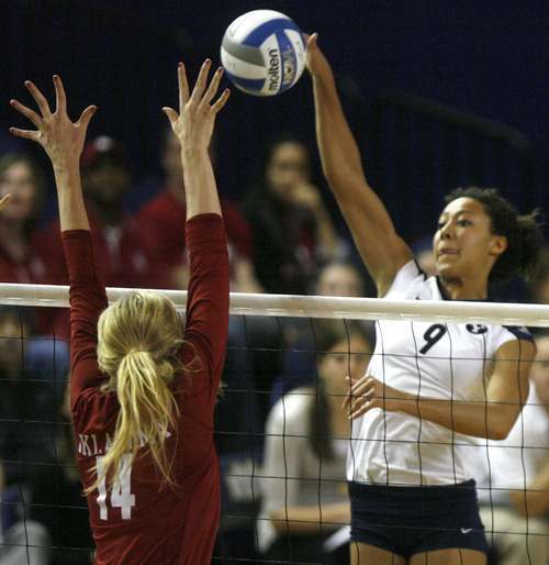 Rick Egan  | The Salt Lake Tribune 

Alexa Gray spikes the ball as Sallie McLaurin defends for Oklahoma, as BYU faced Oklahoma in NCAA  volleyball action at the Smith Fieldhouse in Provo, Saturday, December 1, 2012.