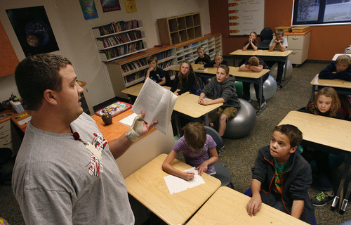Scott Sommerdorf  |  The Salt Lake Tribune              
Teacher John Lott reads to his class at Endeavour Elementary in Kaysville. Utah recently released new accountability data for all Utah public schools, and Endeavour Elementary has the third-highest score in the state under the new system.