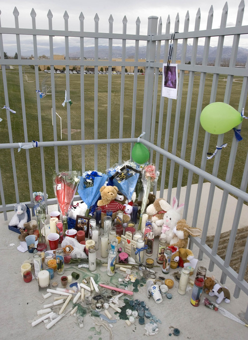 Paul Fraughton  |  The Salt Lake Tribune
A photo and rosary hang Friday above a small memorial shrine on the pedestrian walkway at 6200 South and 2700 West, where a 14-year-old fatally shot himself Thursday.