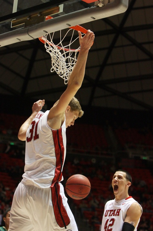 Kim Raff  |  The Salt Lake Tribune
University of Utah player (right) Jason Washburn reacts as teammate Dallin Bachynski dunks the ball against Sacramento State during a men's basketball game at the Huntsman Center in Salt Lake City on November 16, 2012. They went on to lose the game 71-74.