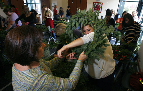 Scott Sommerdorf  |  The Salt Lake Tribune              
Red Butte volunteer Kathy Siskin, left, helps Tiffany Rettie with her wreath during a wreath-making class led by Scott Mower at Red Butte Garden, Sunday, December 2, 2012.