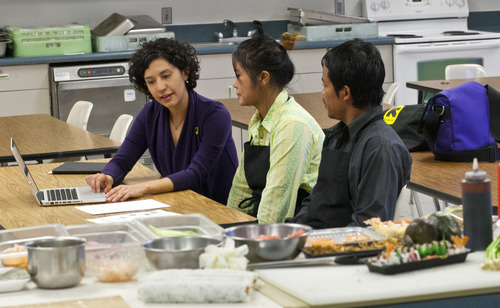 Chris Detrick  |  The Salt Lake Tribune
Natalie El-Deiry helps teach Family Fresh Sushi owners Tial (Lucy) Philip and Dar Ki about the food business at the Horizonte Instruction and Training Center Friday November 30, 2012. Salt Lake County and the International Rescue Committee are starting up a program to teach refugees and others how to get into the food business. This can include making food for wholesale distribution or operating a restaurant.