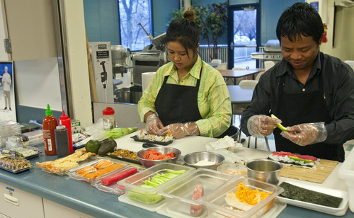 Chris Detrick  |  The Salt Lake Tribune
Family Fresh Sushi owners Tial (Lucy) Philip and Dar Ki make sushi at the Horizonte Instruction and Training Center Friday November 30, 2012. Salt Lake County and the International Rescue Committee are starting up a program to teach refugees and others how to get into the food business. This can include making food for wholesale distribution or operating a restaurant.