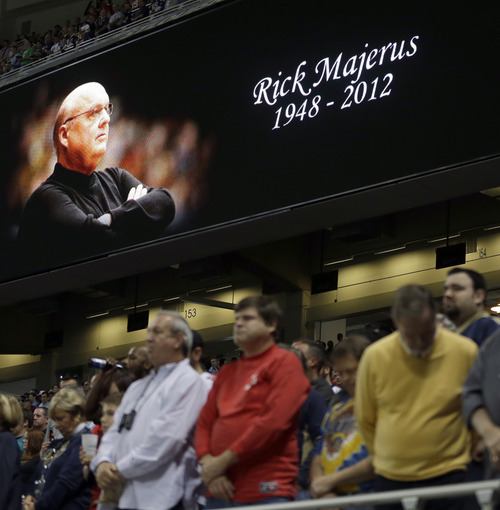 Fans pause during a moment of silence for Saint Louis University basketball coach Rick Majerus before the start of an NFL football game between the St. Louis Rams and the San Francisco 49ers Sunday, Dec. 2, 2012, in St. Louis. Majerus, the jovial college basketball coach who led Utah to the 1998 NCAA final and had only one losing season in 25 years with four schools, died Saturday, Dec. 1, 2012. He was 64. (AP Photo/Jeff Roberson)