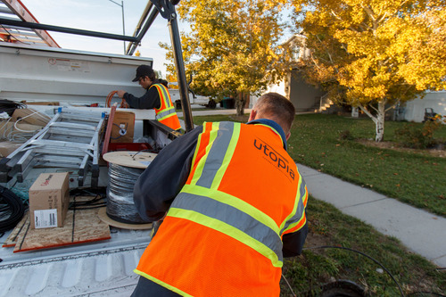 Trent Nelson  |  The Salt Lake Tribune
Todd, right, and Tate Jones hook up a Murray home to Utopia's fiber-optic network, Tuesday October 30, 2012.