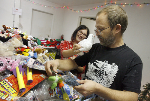 Francisco Kjolseth  |  The Salt Lake Tribune
Toni Webb tries to convince Don Roberts of a toy pigeon as a good stocking stuffer for their 6-year-old daughter as the family, living at The Road Home pick out gifts and clothes for the holidays on Tuesday, December 4, 2012. Representatives from the YWCA, The Road Home, and Volunteers of America, Utah, began the 18th annual Candy Cane Corner holiday store, where low-income parents select new clothes and toys for their children along with necessities for themselves.
