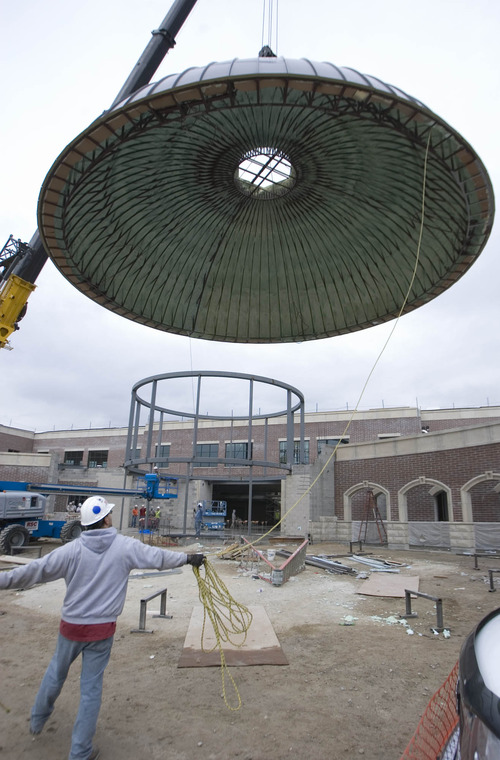 Paul Fraughton  |   Salt Lake Tribune
A construction crane raises a 13 ton steel and aluminum  dome off the ground to be put into place as a central feature of  Corner Canyon High School under construction in Draper.
 Wednesday, December 5, 2012