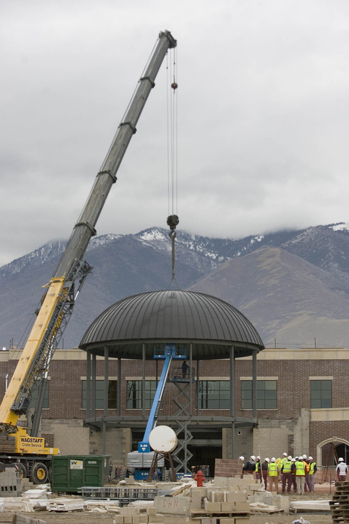 Paul Fraughton  |   Salt Lake Tribune
A construction crane lowers a 13 ton steel and aluminum  dome into place at  Corner Canyon High School under construction in Draper.
 Wednesday, December 5, 2012