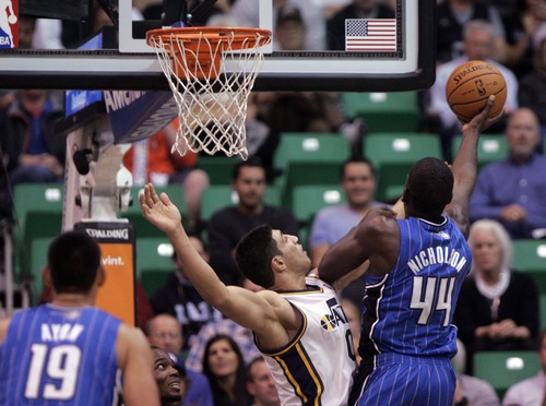Kim Raff  |  The Salt Lake Tribune
(left) Utah Jazz center Enes Kanter (0) defends Orlando Magic power forward Andrew Nicholson (44) as he takes a shot during a game at EnergySolutions Arena in Salt Lake City on December 5, 2012. Jazz went on to win 87-81.