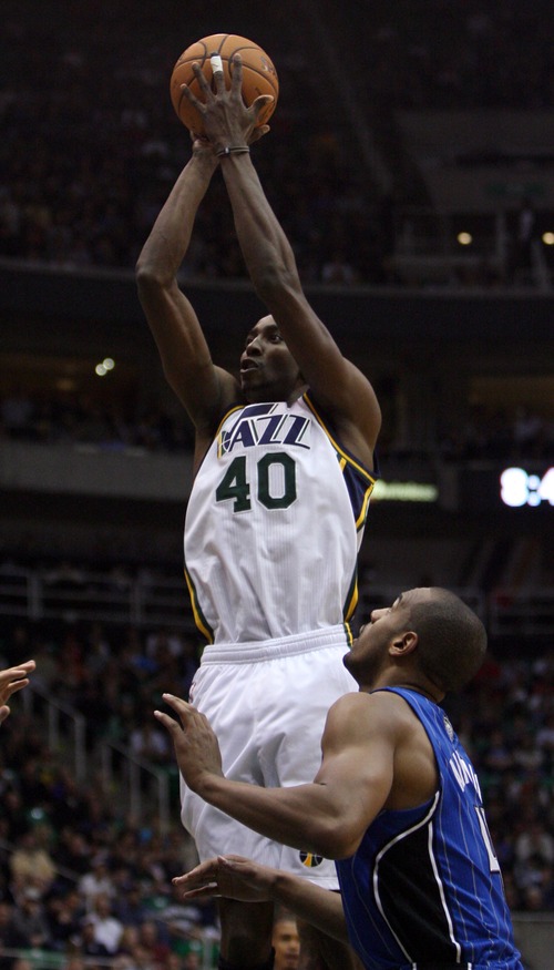 Kim Raff  |  The Salt Lake Tribune
Utah Jazz small forward Jeremy Evans (40) takes a shot as (right) Orlando Magic small forward Arron Afflalo (4) defends during a game at EnergySolutions Arena in Salt Lake City on December 5, 2012. Jazz went on to win 87-81.