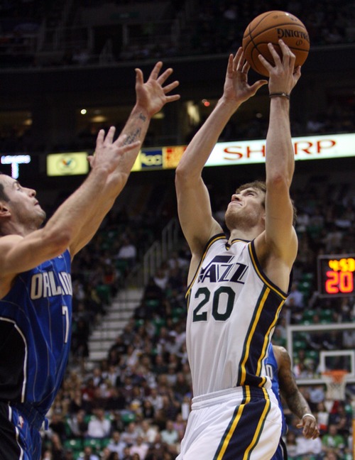 Kim Raff  |  The Salt Lake Tribune
(right) Utah Jazz shooting guard Gordon Hayward (20) catches a pass over the hands of (left) Orlando Magic shooting guard J.J. Redick (7) during a game at EnergySolutions Arena in Salt Lake City on December 5, 2012. Jazz went on to win 87-81.