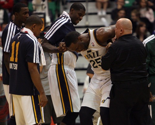 Kim Raff  |  The Salt Lake Tribune
Utah Jazz center Al Jefferson (25) is helped off of the court after being injured during a game against Orlando at EnergySolutions Arena in Salt Lake City on December 5, 2012. Jazz went on to win 87-81.