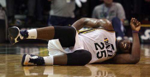 Kim Raff  |  The Salt Lake Tribune
Utah Jazz center Al Jefferson (25) lays on the court after being injured during a game against Orlando at EnergySolutions Arena in Salt Lake City on December 5, 2012. Jazz went on to win 87-81.