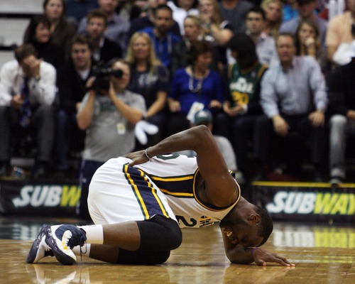 Kim Raff  |  The Salt Lake Tribune
Utah Jazz center Al Jefferson (25) falls on the court after being injured during a game against Orlando at EnergySolutions Arena in Salt Lake City on December 5, 2012. Jazz went on to win 87-81.
