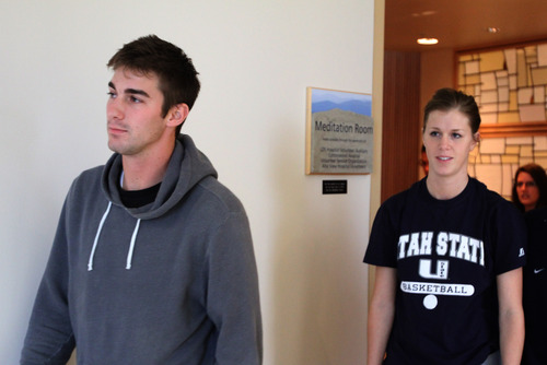 Rick Egan  | The Salt Lake Tribune 

John Berger and his sister Lauren Berger leave the meditation room, after making a statement about their brother, USU basketball player Danny Berger at Intermountain Medical Center in Murray, Wednesday, December 5, 2012. Danny Berger collapsed during basketball practice Tuesday in Logan.
