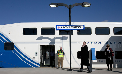 Steve Griffin |  The Salt Lake Tribune
People walk past a FrontRunner train at the Provo Station during UTA ceremony to open the new commuter rail line between Salt Lake City and Provo Thursday, December 6, 2012.