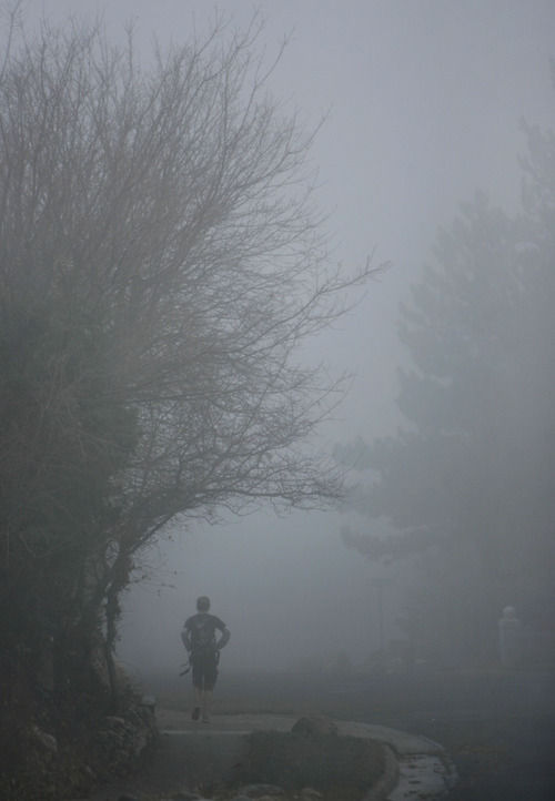 Francisco Kjolseth  |  The Salt Lake Tribune
Heavy fog envelops a student heading to school in the early hours in Olympus Cove on Thursday, Dec. 6, 2012.