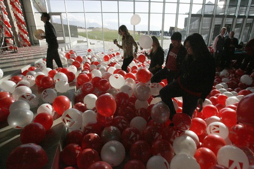 Paul Fraughton  |  The Salt Lake Tribune
Employees and guests wade through a sea of balloons at the official opening Adobe Systems new building in Lehi.