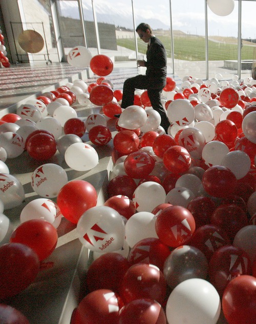 Paul Fraughton  |  The Salt Lake Tribune
An Adobe employee wades through a sea of balloons at the company's grand opening of its new building near Point of the Mountain. Friday, December 7, 2012