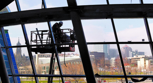 Al Hartmann  |  The Salt Lake Tribune
A worker on a high lift works on the north side exterior windows of the new Salt Lake City Public Safety Building at the corner of 300 East and 500 South with its view of downtown Salt Lake to the north and west on Thursday, Dec. 6, 2012. The building is about 75 percent complete. The sweeping lines of the building with hundreds of windows complements the design of the Salt Lake Public Library across the street to the west.