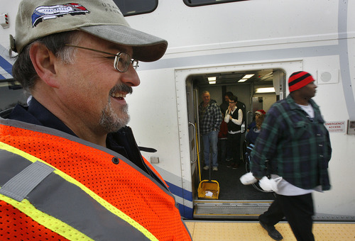 Scott Sommerdorf  |  The Salt Lake Tribune              
Mechanic Cory Lamb helped out with getting passengers boarded in Salt Lake City for the free ride to Provo on FrontRunner, Saturday, December 8, 2012. The public was invited to ride the new FrontRunner line linking Provo and Salt Lake City starting at 10 a.m.