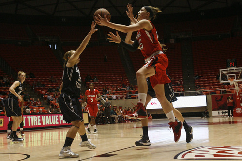 Chris Detrick  |  The Salt Lake Tribune
Utah Utes forward Michelle Plouffe (15) shoots past Brigham Young Cougars guard Haley Steed (33) during the first half of the game at the Huntsman Center Saturday December 8, 2012. BYU is winning the game 28-21 at halftime.