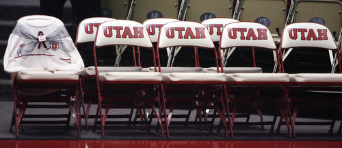 An empty chair courtside is draped with one of former Utah head coach Rick Majerus' trademark cream sweaters during an NCAA college basketball game between Utah and Boise State, Wednesday, Dec. 5, 2012, in Salt Lake City.  Numerous video tributes and a patch on Utah uniforms memorialized Majerus, who died Saturday, Dec. 1. Utah won 76-55. (AP Photo/The Salt Lake Tribune, Steve Griffin)  DESERET NEWS OUT; LOCAL TV OUT; MAGS OUT