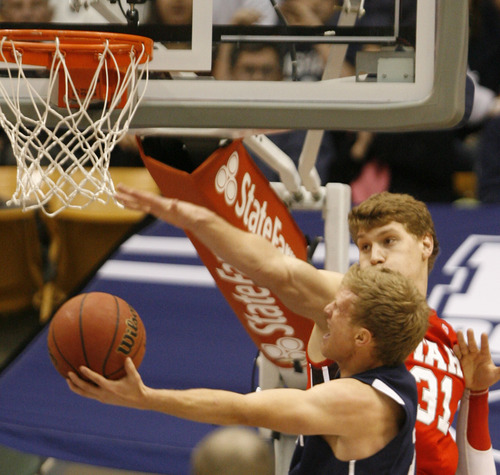 Rick Egan  | The Salt Lake Tribune 

Brigham Young Cougars guard Tyler Haws (3) goes up for a shot, as Utah Utes center Dallin Bachynski (31) defents, in basketball action between the Brigham Young Cougars and the Utah Utes at the Marriott Center in Provo, Saturday, December 8, 2012.