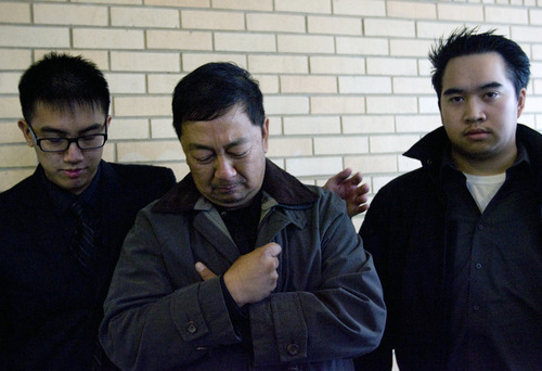 Kim Raff  |  The Salt Lake Tribune
Nhuan Phan, center, father of David Phan, is comforted by David's older brother Don, left, as the family speaks Sunday for the first time about the 14-year-old who took his own life near Bennion Junior High School. Viet Dinh looks on during a news conference outside the Kearns Public Library.