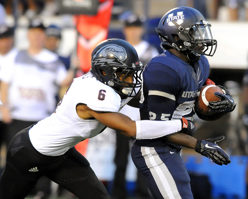 Utah State running back Kerwynn Williams breaks an attempted tackle by Southern Utah defensive back Tyree Mills (6) during their NCAA college football game, Thursday, Aug. 30, 2012, in Logan, Utah. (AP Photo/The Herald Journal, Eli Lucero)