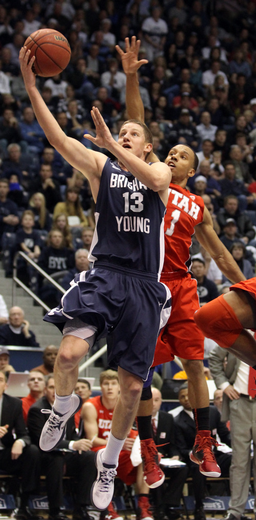 Rick Egan  | The Salt Lake Tribune 

Brigham Young Cougars guard Brock Zylstra (13) takes the ball inside, as Utah Utes guard Glen Dean (1) defends, in basketball action between the Brigham Young Cougars and the Utah Utes at the Marriott Center in Provo, Saurday, December 8, 2012.