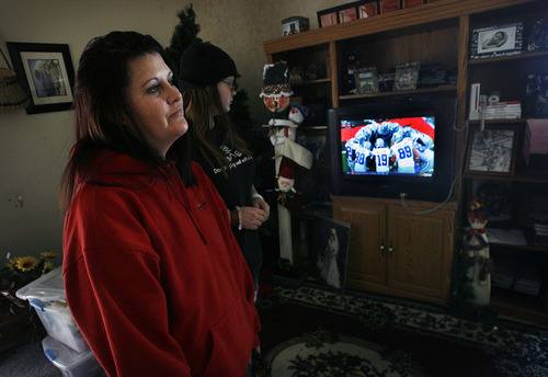 Scott Sommerdorf  |  The Salt Lake Tribune              
Kristin Poulsen, left, and her daughter Kassidie, watch the Bengals vs Cowboys NFL game at their home across the street from Sofa's Bar, Sunday December 9, 2012. Sofa's Bar in Garland, Utah, began selling beer on Sunday Dec. 9 and will continue to sell on Sundays through Super Bowl Sunday on Feb. 13.