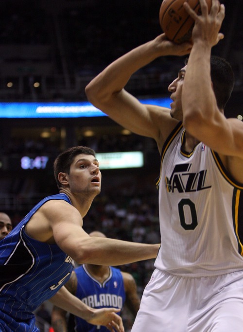 Kim Raff  |  The Salt Lake Tribune
(right) Utah Jazz center Enes Kanter (0) looks to pass past Orlando Magic center Nikola Vucevic (9) during a game at EnergySolutions Arena in Salt Lake City on December 5, 2012. Jazz went on to win 87-81.
