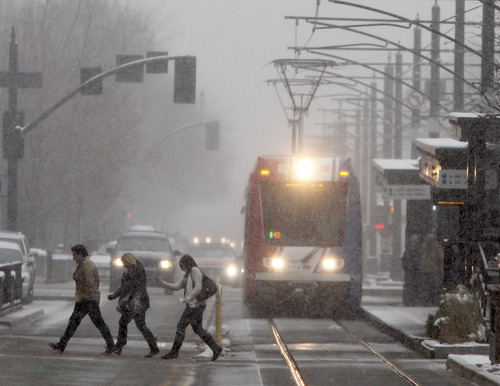 Al Hartmann  |  The Salt Lake Tribune
People cross Main Street in Salt Lake City between South Temple and 100 South during the noontime snowstorm.