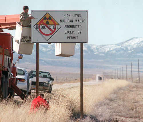 Steve Griffin  |  Tribune file photo 
Then-Utah Gov. Mike Leavitt tightens the bolts on a new sign closing the Skull Valley Road to nuclear waste shipments. The state tried multiple strategies to block a planned high-level waste storage site on tribal lands, but all of them failed. The federal government finally stepped in to rule against the facility.