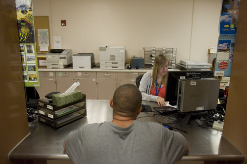 Kim Raff | The Salt Lake Tribune
Pretrial jail screener Michelle Briggs checks the background of a man who was recently brought into the Salt Lake County Jail to see if he qualifies for pretrial release.