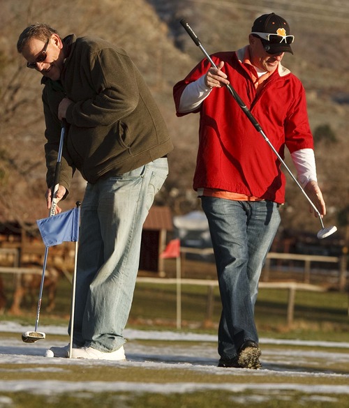 Leah Hogsten  |  The Salt Lake Tribune
l-r Mark Smedley and Dave Williams  of Kaysville sink some practice putts Tuesday December 11, 2012 in Kaysville at Davis Park Golf Course. No matter what the weather is like, the two can be seen on the putting green nearly every day, snow or no snow.