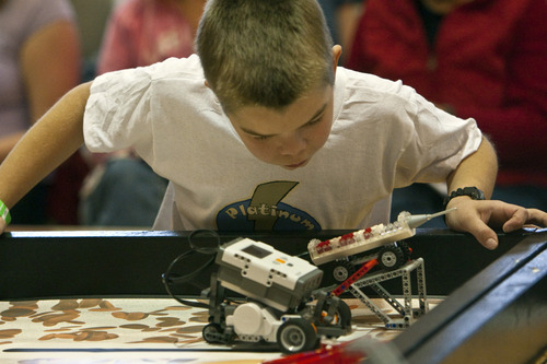 Chris Detrick  |  Tribune file photo 
In the FIRST LEGO League Championship in 2011 at the University of Utah, Platinum Thunder's Josh Bosley, 10, watches the team robot. The 2012 state championship is Jan. 28 but qualifiers begin this weekend.