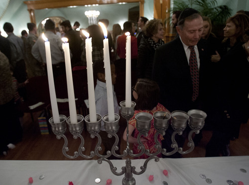 Steve Griffin | The Salt Lake Tribune
Candles burn during menorah lighting ceremony at the Governor's Mansion in Salt Lake City Tuesday December 11, 2012. The Hanukkah celebration was attended by dignitaries, local families, and community leaders. Rabbi Benny Zippel emphasized the importance of the state celebrating the constitutional "freedom of religion," not a "freedom from religion."