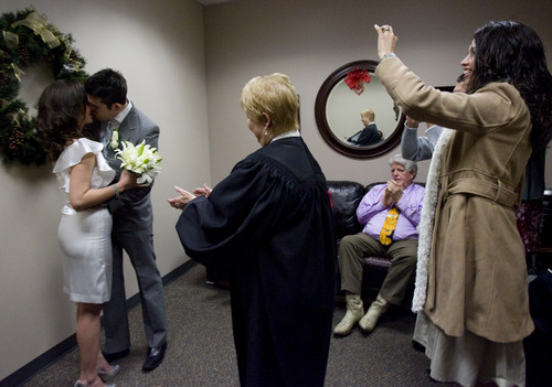 Kim Raff  |  The Salt Lake Tribune
Friends and family cheer as (left) Edna Garcia and J.C. Martinez get married by Deputy Clerk Darlene Von Bank at the Salt Lake County Clerk office in Salt Lake City on December 12, 2012. "Nobody will ever forget this date. We wanted to get married before the end of the world. It's kind of a fun thing," says Garcia of the 12/12/12 date.