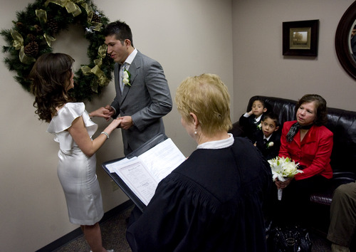 Kim Raff  |  The Salt Lake Tribune
(left) Edna Garcia and J.C. Martinez get married by Deputy Clerk Darlene Von Bank at the Salt Lake County Clerk office in Salt Lake City on December 12, 2012. "Nobody will ever forget this date. We wanted to get married before the end of the world. It's kind of a fun thing," says Garcia of the 12/12/12 date.